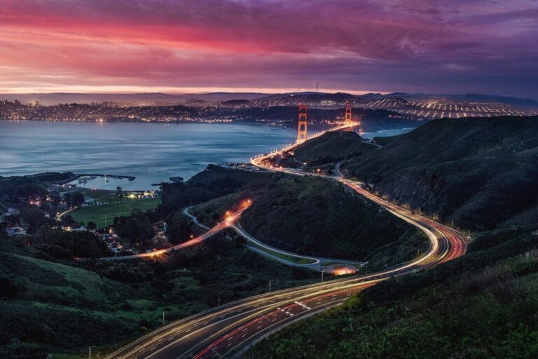 Golden Gate Bridge at sunset with city lights