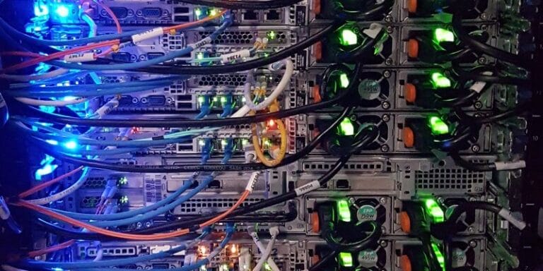 Server racks with blue and green LEDs blinking.