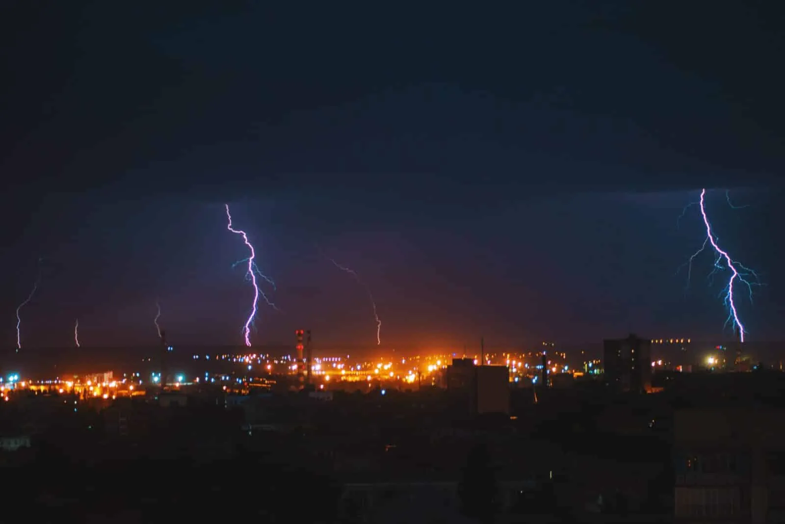 Lightning storm over city at night