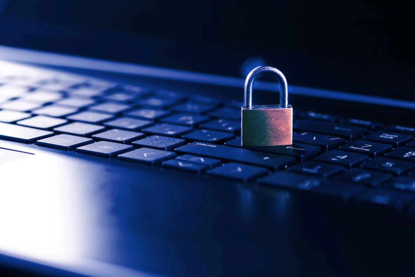 Padlock on laptop keyboard for security concept.
