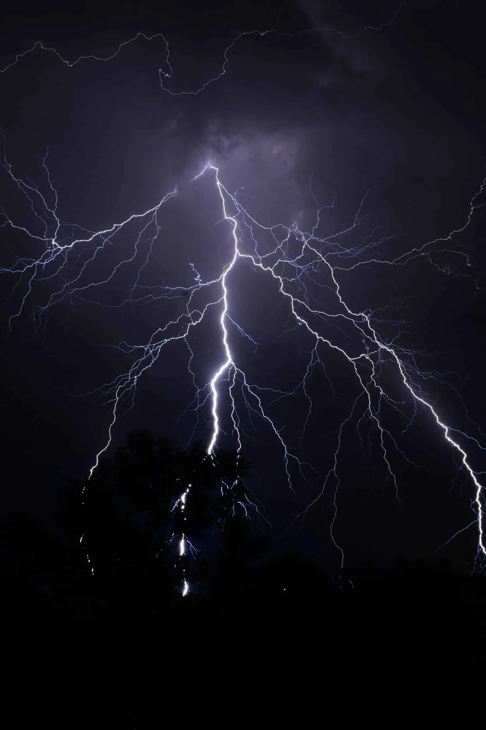 Dramatic lightning storm in dark night sky.